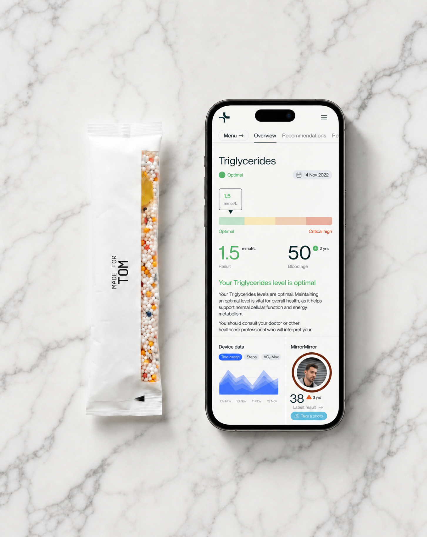 Lova Core daily sachet next to phone showing personalised dashboard, on white marble